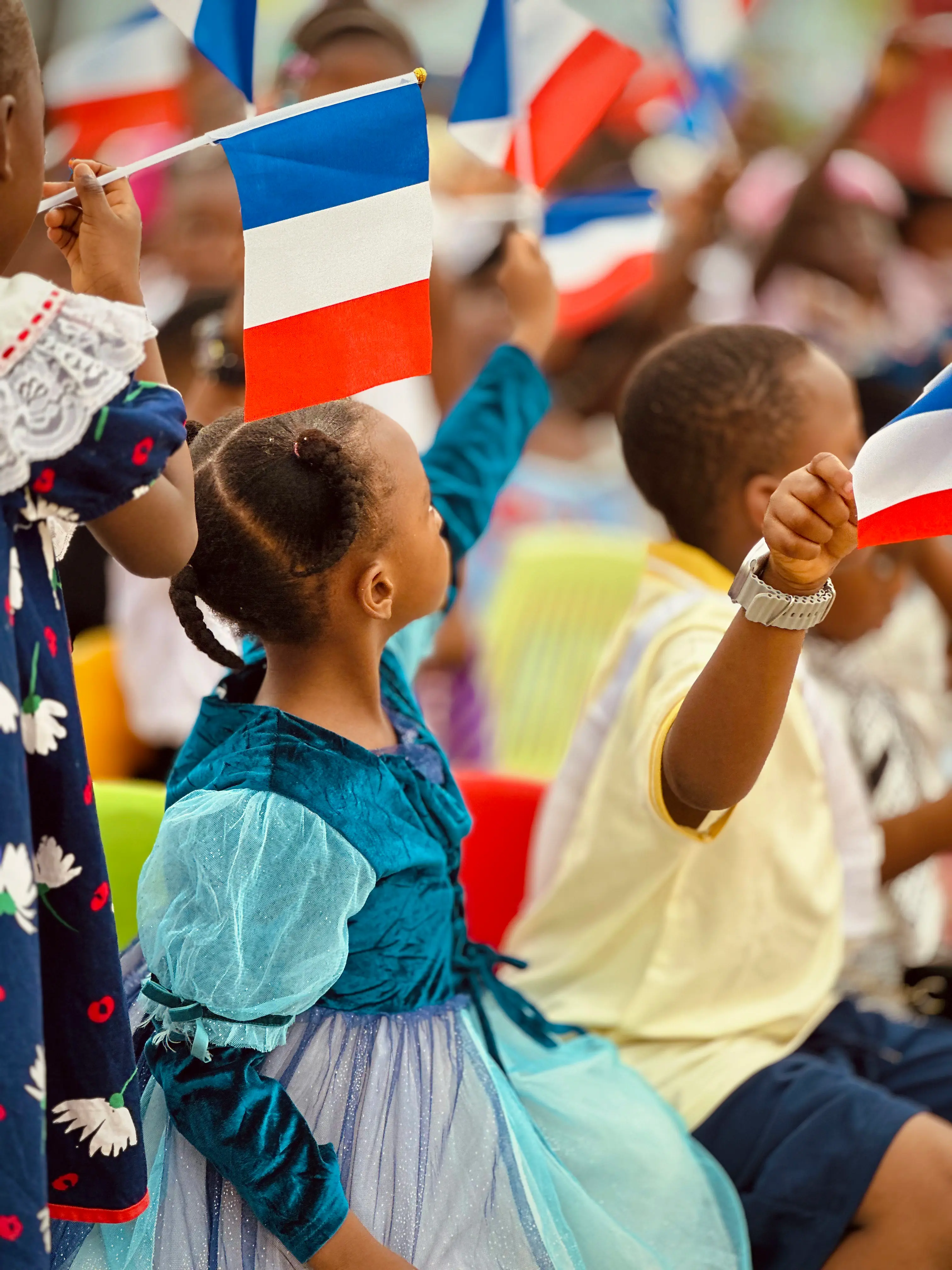 Children celebrating French Week with French flags
